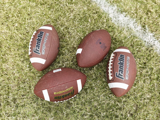 closeup-four-footballs-on-field-https://unsplash.com/photos/red-and-white-football-on-green-grass-ySVcOaCv-yM